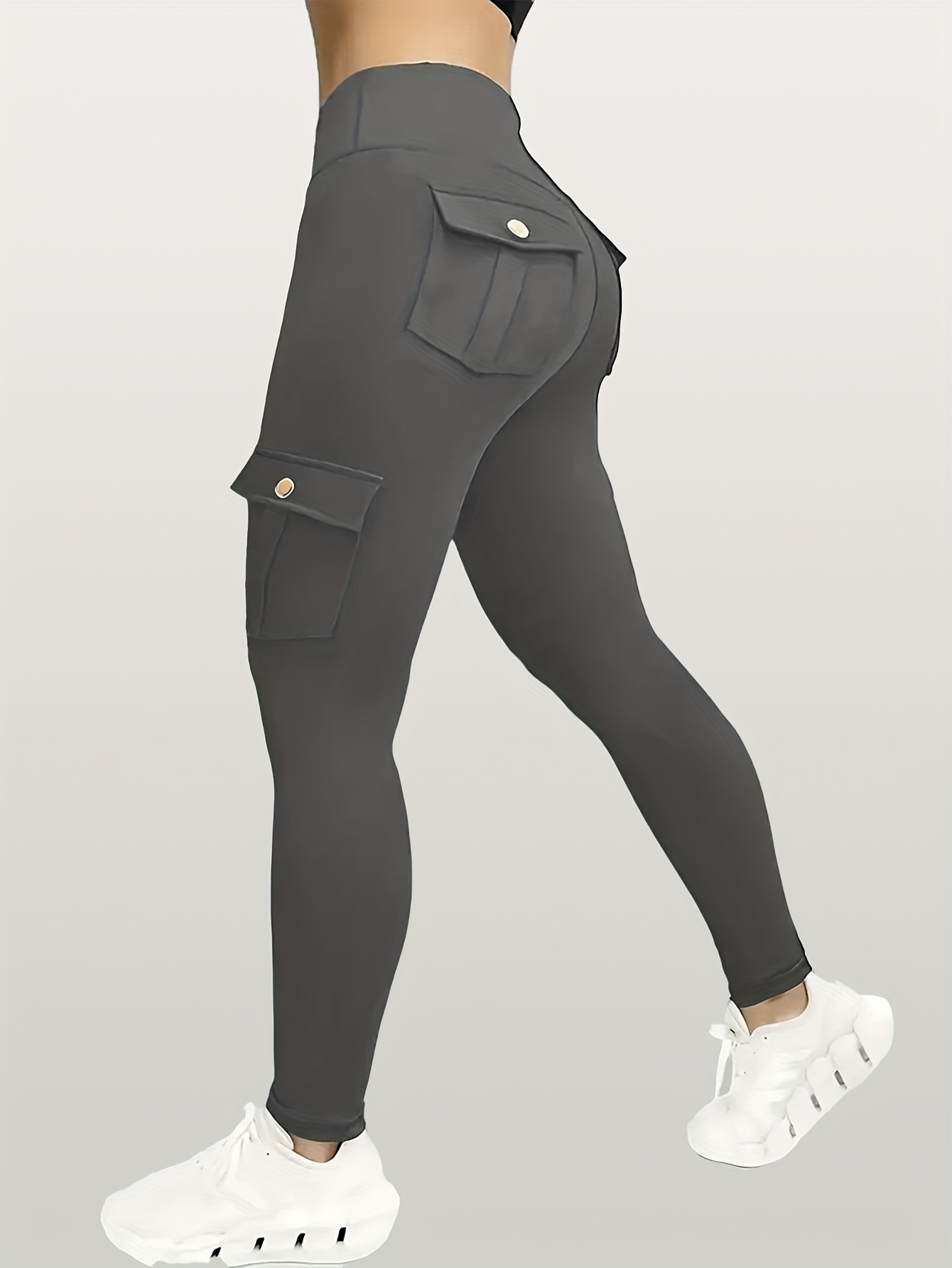A woman wearing a grey yoga leggings sold by 100 Spartans