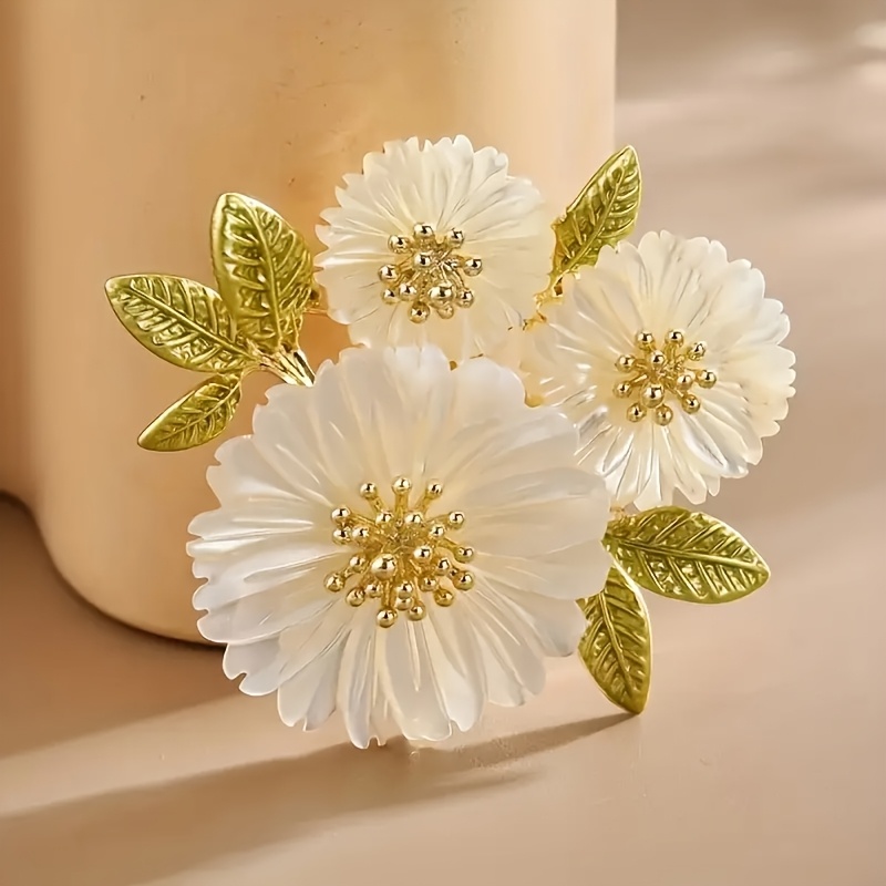 a   floral brooch with a     for women to wear on festive occasions birthdays dates balls parties vacations shopping or daily commutes