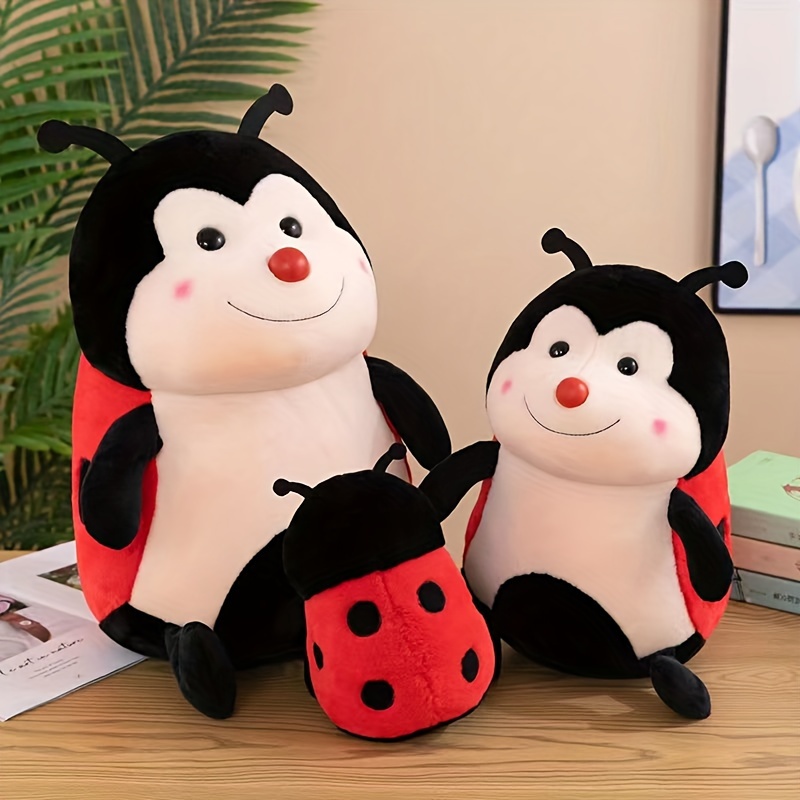 

Plush Ladybug Toy Doll On The Sofa Bed For Cuddling, A Pillow For Sleeping Together, A Holiday Gift For Valentine's Day.