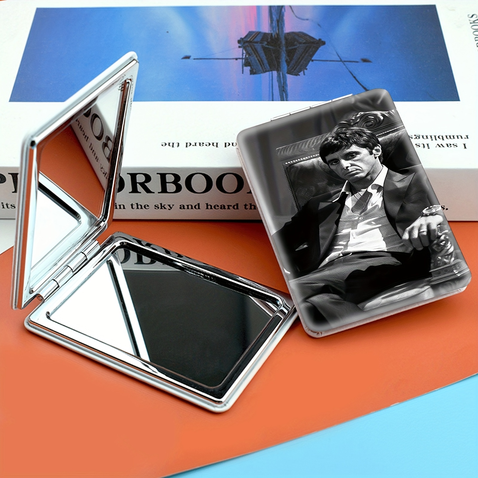 TEMU A Portable Folding Makeup Mirror, Featuring A Well-dressed Man Sitting Comfortably In A Chair With A Relaxed Demeanor. And White Tones Highlight