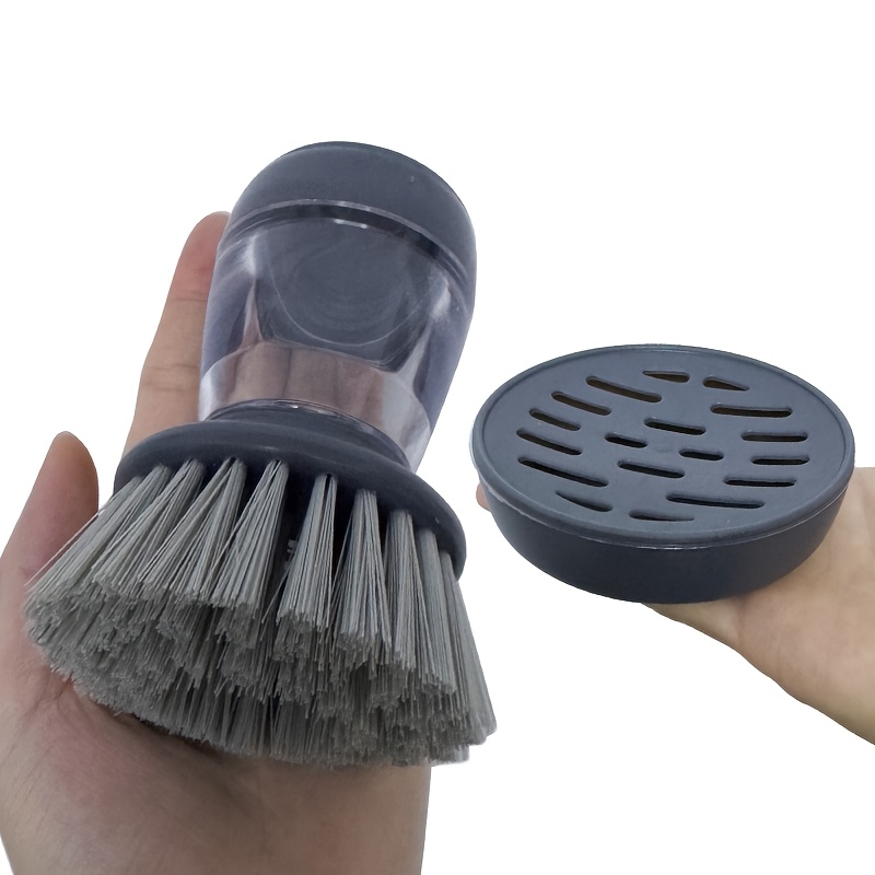 E-shop Ein zweiteiliges Handwerkzeug zur Topfputzreinigung, bestehend aus einer Basis, einem Reinigungsmechanismus und einem Flüssigkeitsspender. Es