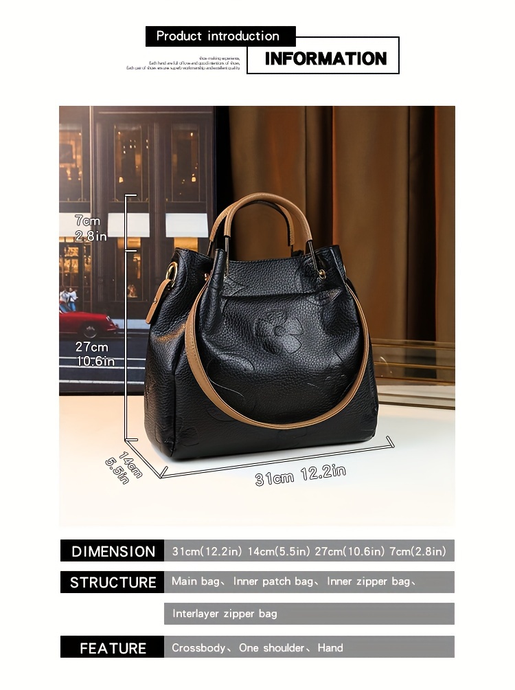 Black handbag held by hand full view