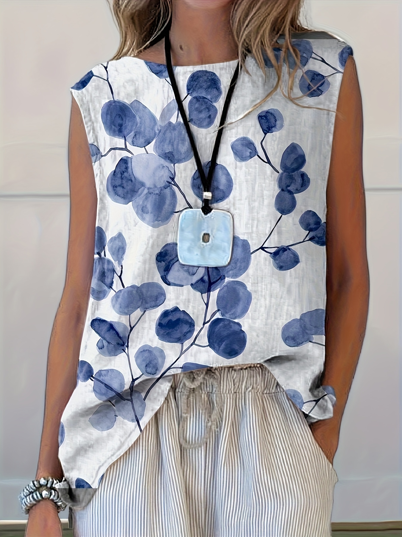 a stylish womens top featuring a full body floral print including tank tops and vests