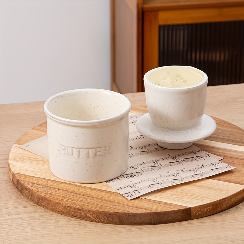 item picture ceramic butter dish with a lid designed for the countertop featuring a   white end ideal for keeping soft butter spreadable this butter holder   a   and   a great housewarming gift