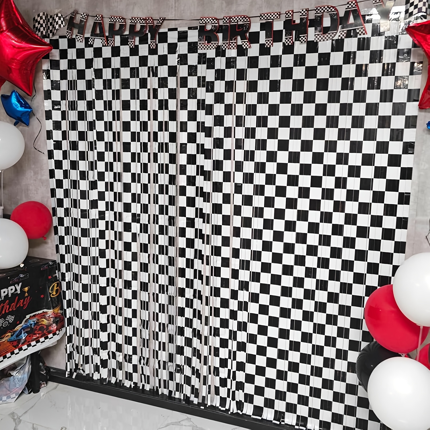 

Decorations For A Birthday Party Featuring , Including A Checkered Backdrop In , And Party Supplies Themed Around Cars.