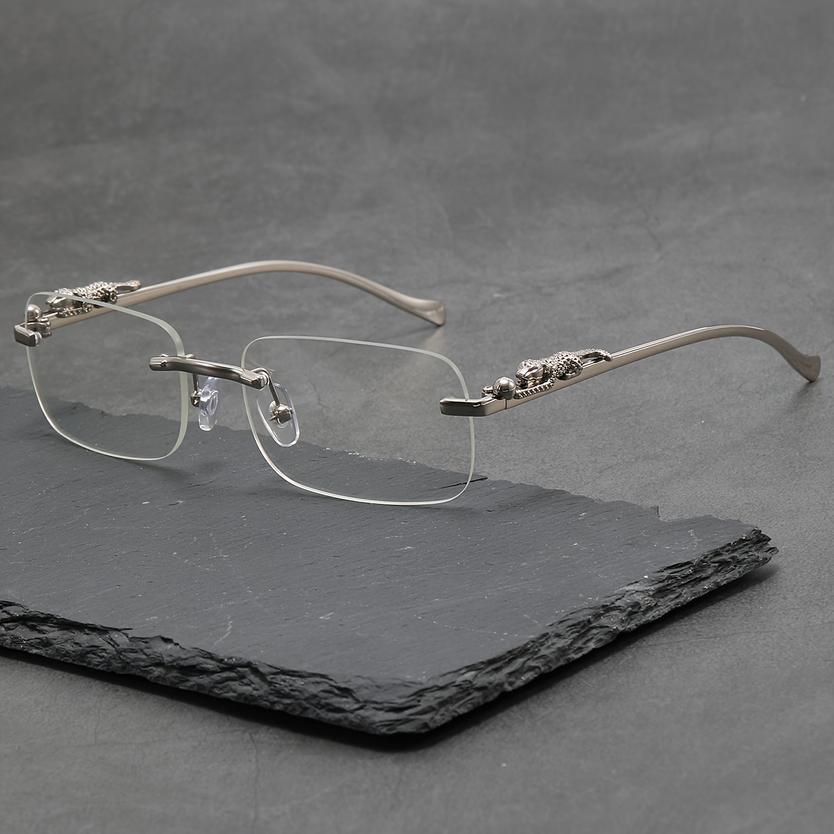

A Pair Of Square Metal Glasses With A Flat Lens.