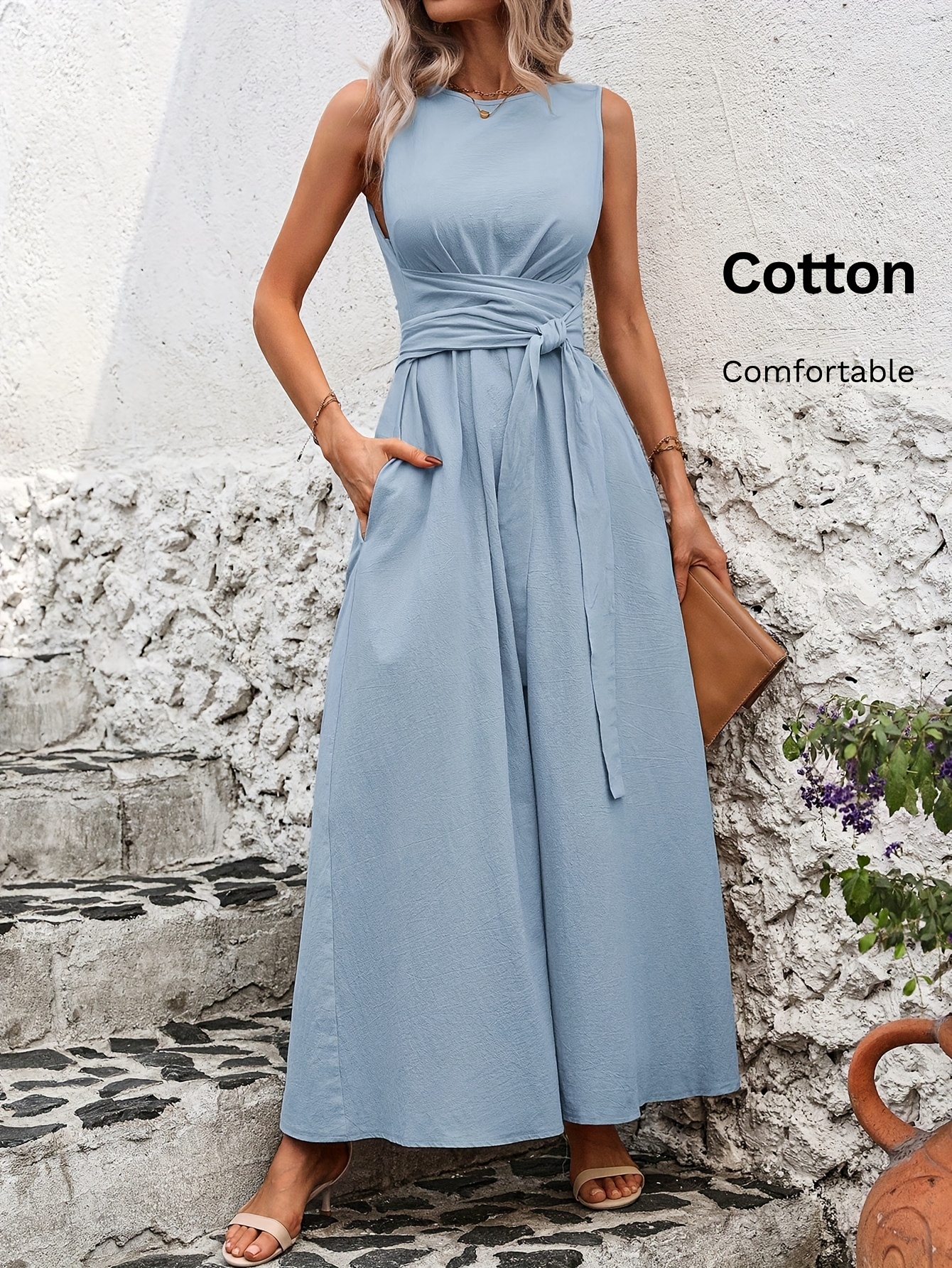 Sleeveless A line cotton casual dress with tie waist and pockets shown on a model