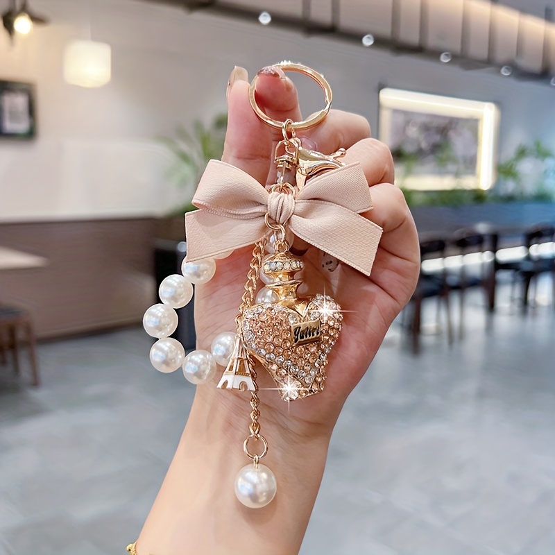 TEMU Creative Water Bottle Keychain Fashionable Bow Perfume Bottle Bag Pendant Exquisite Pearl Chain Car Key Chain Ring Gift Additions