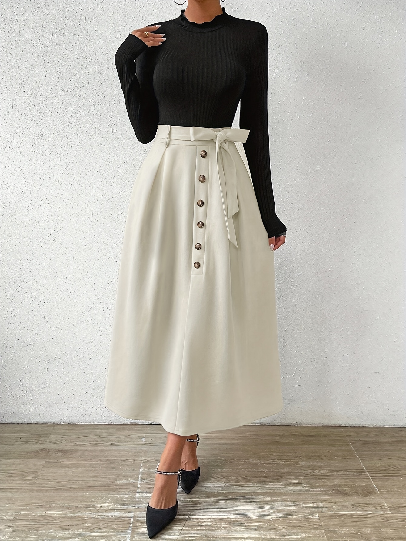Model showcasing Newness Parisian Chic Midi Skirt Set a stylish two piece outfit featuring a midi skirt and coordinating top The set is elegantly designed and perfect for various occasions