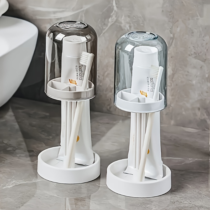 bathroom toothbrush organizer with a dust cover designed to hold toothpaste and toothbrushes it features drainage and water   capabilities making it a multifunctional storage solution for home use   and   adds to