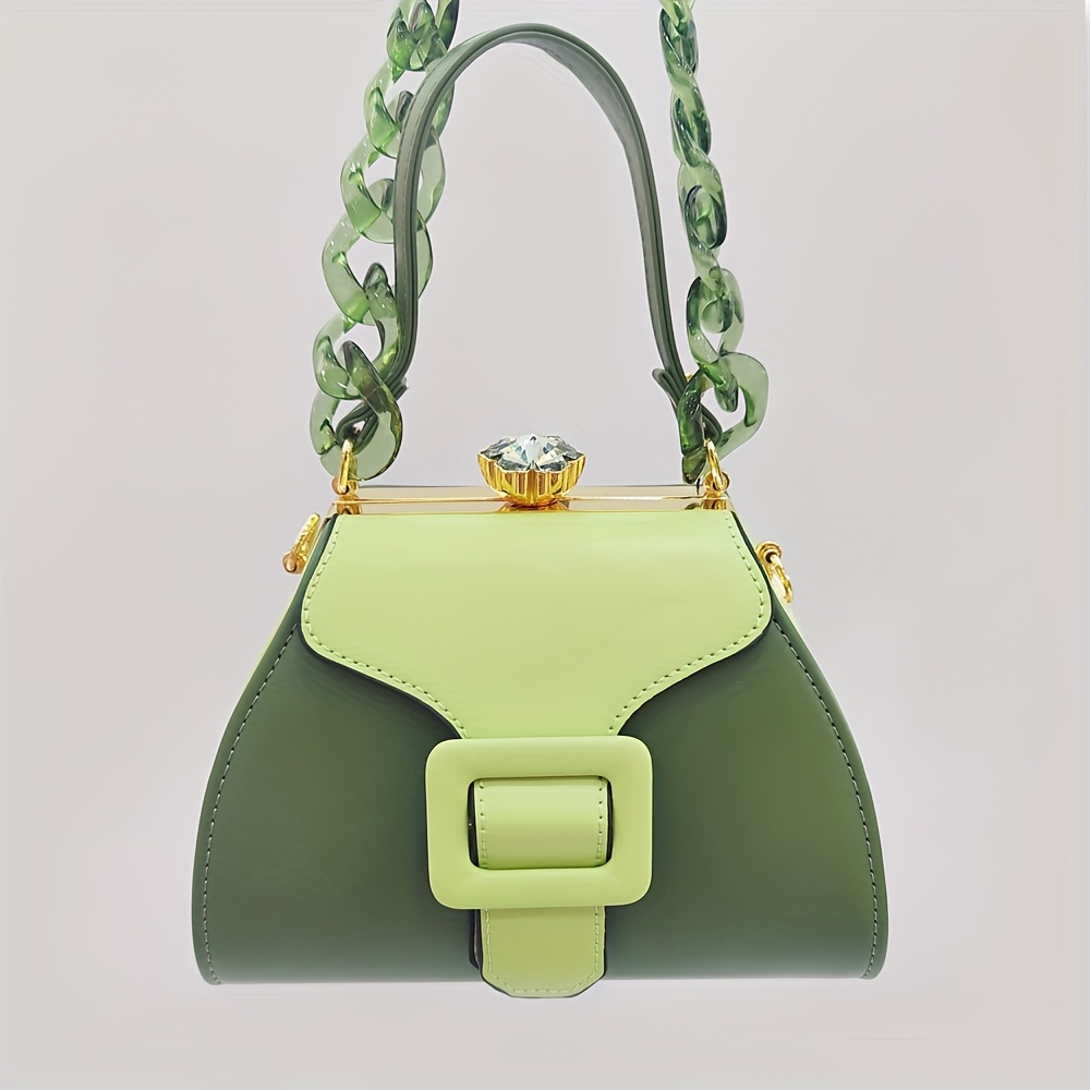 Stylish Two-Tone Round Handbag Made of Durable, Featuring a Detachable Acrylic Chain And Snap Closure. This Versatile Handbag Is Perfect for Both Parties And Everyday Use.