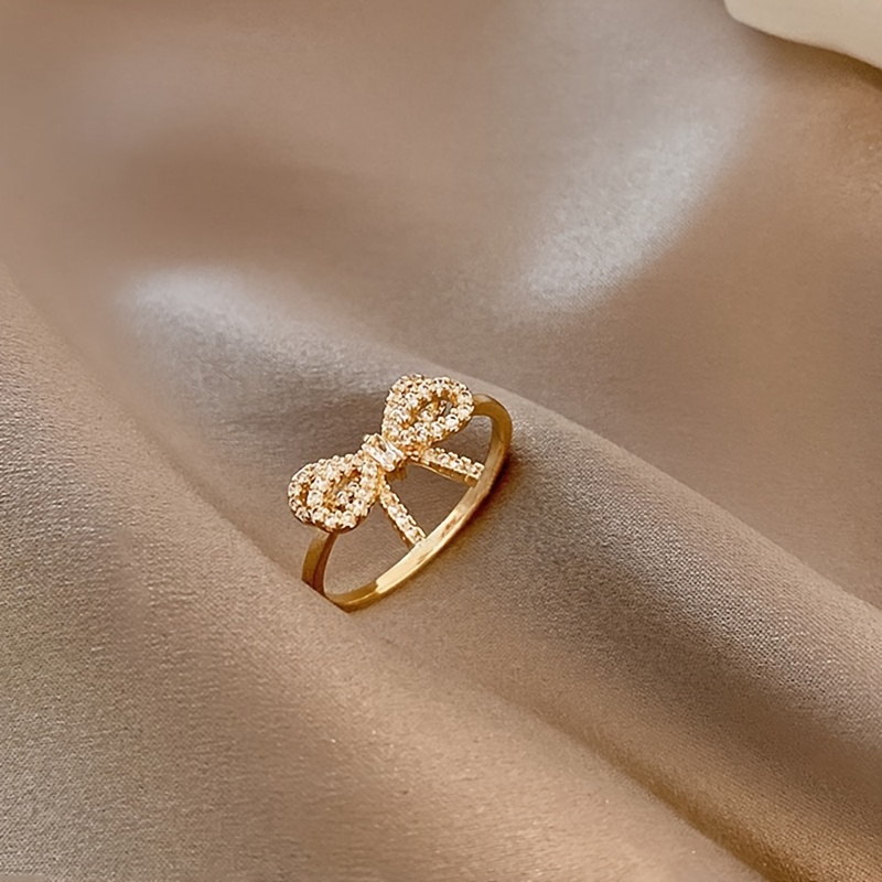 Golden Tone Bow Knot Ring with Sparkling Cubic Zirconia Accents