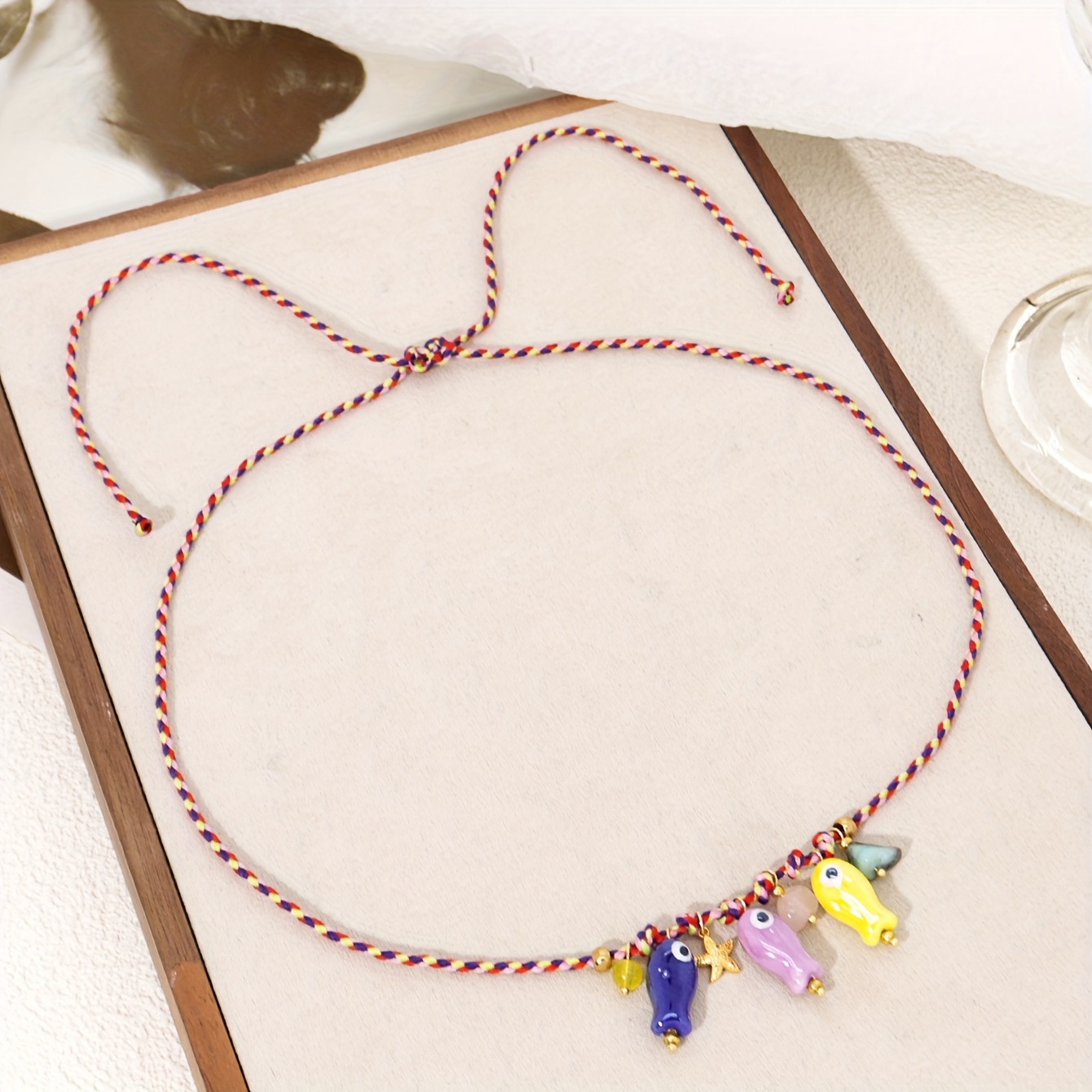 A Stylish Women's Necklace Featuring A Delicate Irregular Stone Ceramic Cartoon Fish Pendant, With A Colorful Adjustable Braided Cord, Perfect For Party And Vacation Jewelry Additions