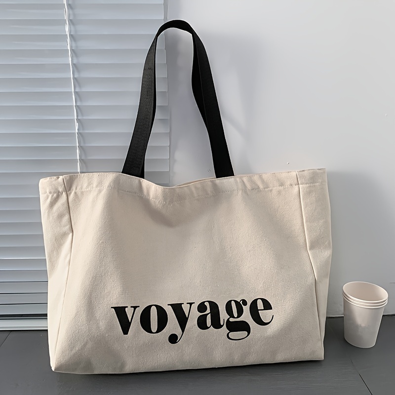 

Grand sac fourre-tout en toile pour femmes avec lettrage « Voyage », sac à main à bandoulière décontracté parfait pour les voyages et le shopping, sac d'école durable