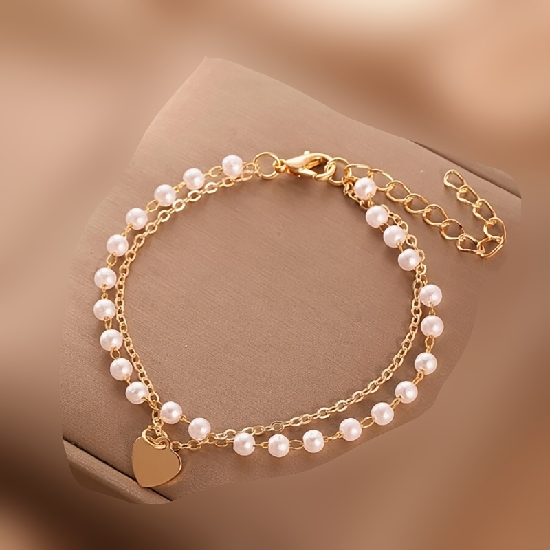 An Elegant And Simple Double-layer Pearl Bracelet With A Heart Pendant, And Versatile Style Suitable For By Women, Gifts, And Attending Parties. Women's Fashionable Bracelet