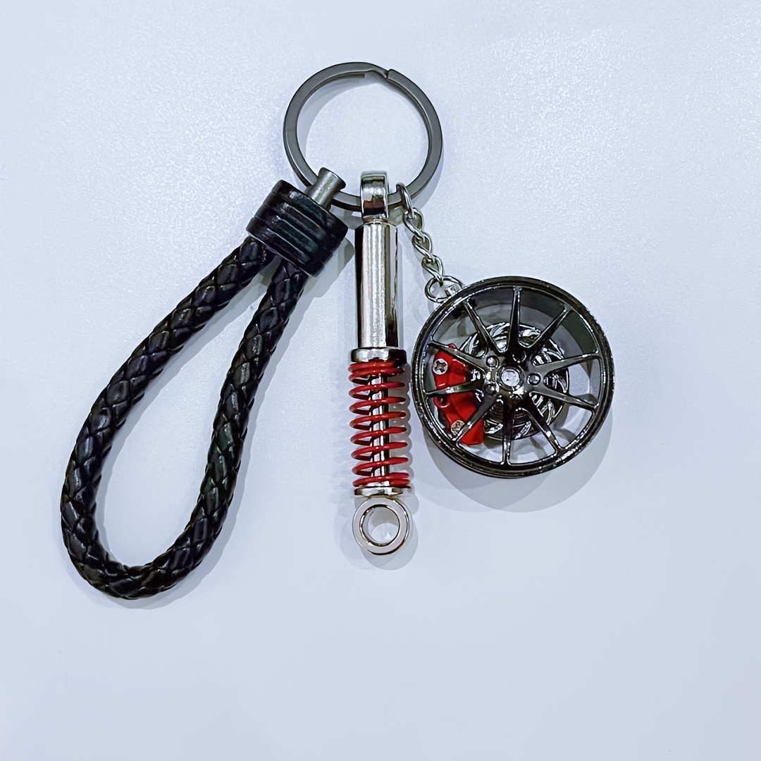 Image of A Unique Keychain For Car Enthusiasts Featuring A Shock Absorber Design, Perfect For Decorating Car Keys Or Bags, And An Ideal Gift For