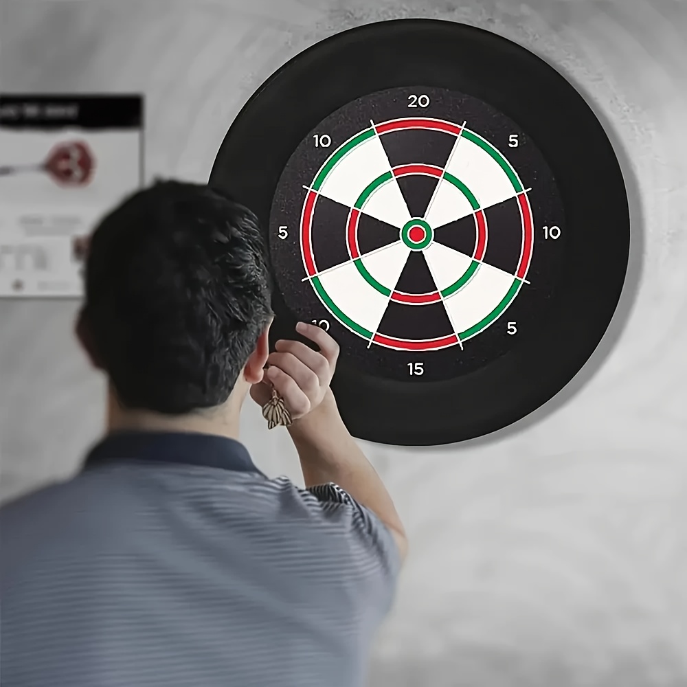 A Black Dartboard Holder Made of EVA Foam for Wall Decoration, Featuring a Protective Pad That Easily Snaps Onto a Standard Dartboard. It Includes a Easy-To-Install Protective Ring And Can Serve As a Wall Sticker, Making It a Great Gift for Parents