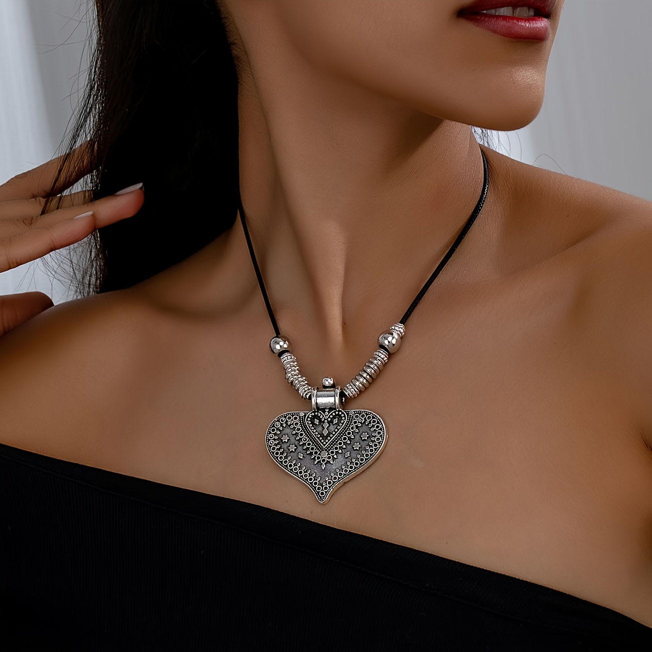 

Artistic Elegance With A Bohemian Style, Featuring A Distressed Relief Design Of Stars And Hearts, Adorned With Golden Floral Patterns On A Pendant Necklace For Women.