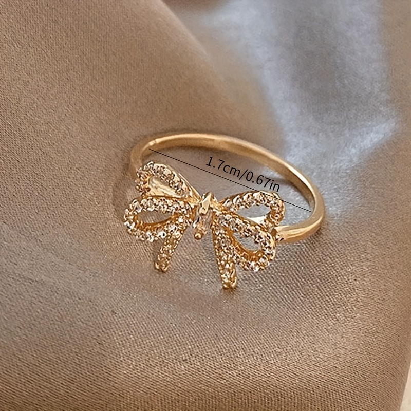 Golden Tone Bow Knot Ring with Sparkling Cubic Zirconia Accents