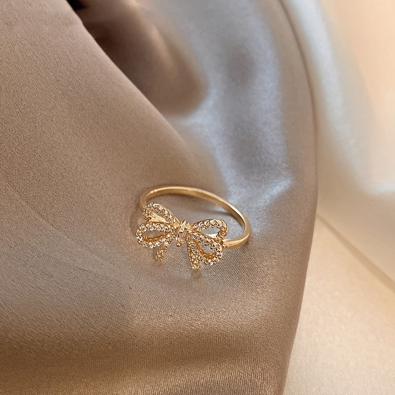 Golden Tone Bow Knot Ring with Sparkling Cubic Zirconia Accents
