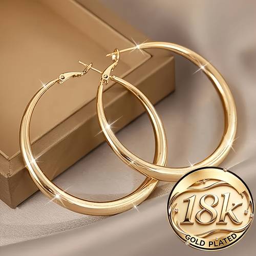a pair of minimalist yet oversized hoop earrings niche and high end stud earrings womens jewelry suitable for daily commuting