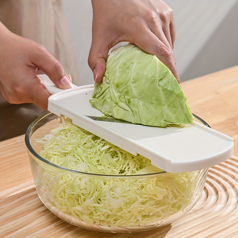 a heavy duty cabbage slicer and chopper with an ergonomic handle an   vegetable cutter suitable for salads carrots   and other     a storage box easy to clean kitchen tool with a durable plastic shell and s