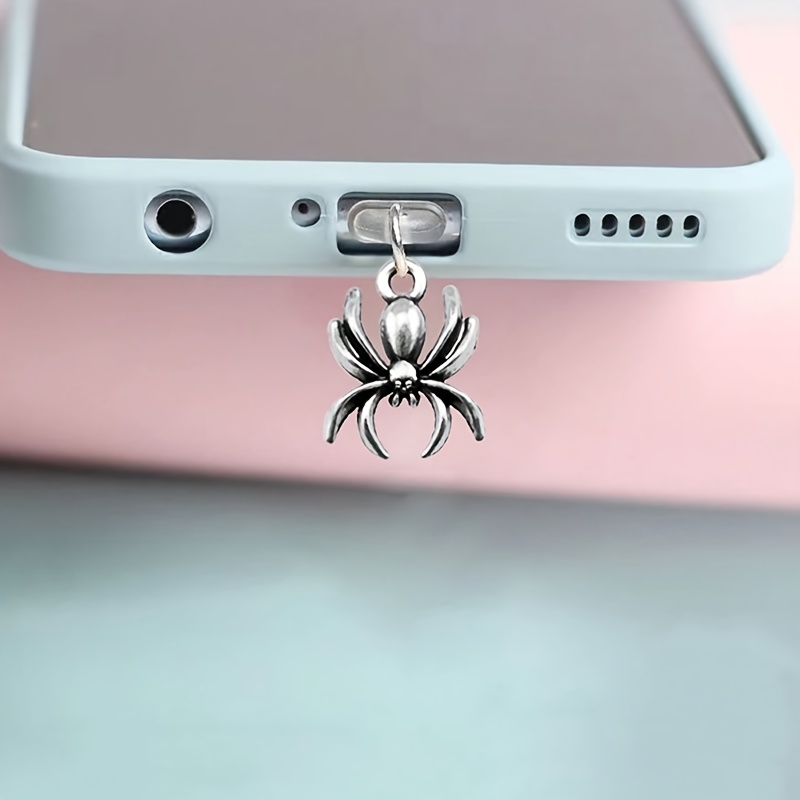 

A Spider-shaped Pendant For Covering The Charging Of A Phone To Prevent Accumulation