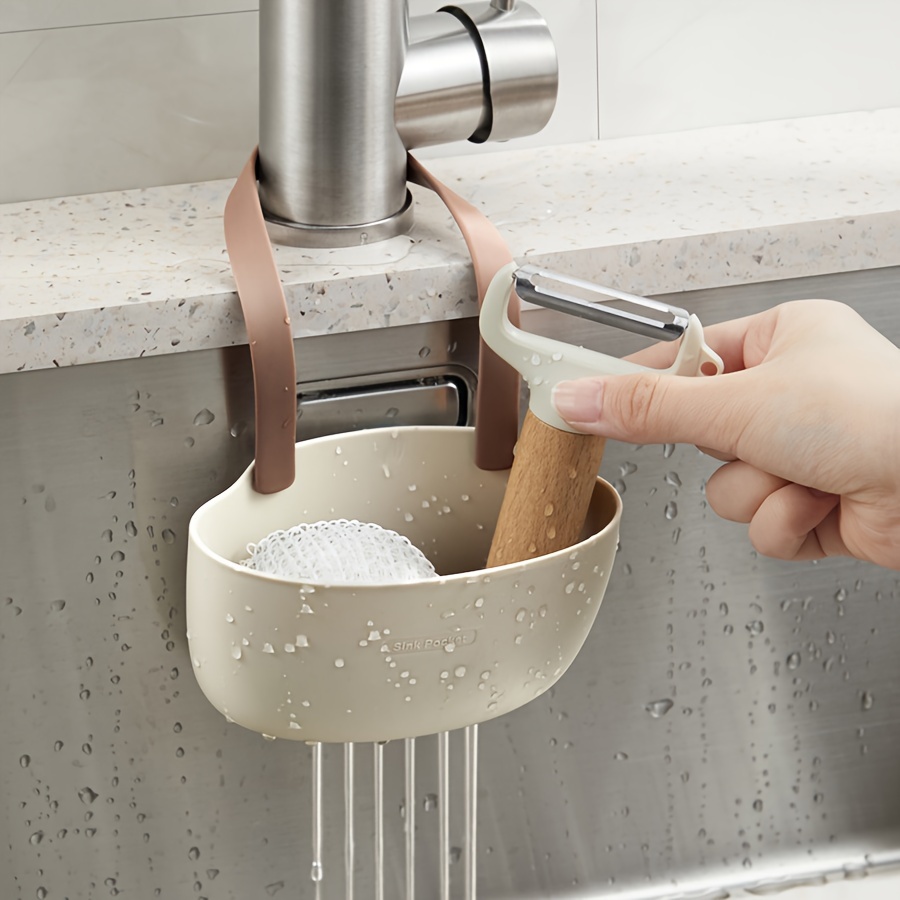 A Modern Plastic Kitchen Sponge Holder With An Adjustable Strap - Versatile, Wall-mounted Design Suitable For Sinks, A Must-have For Organizing Sponges And Soap In Bathrooms And Kitchens