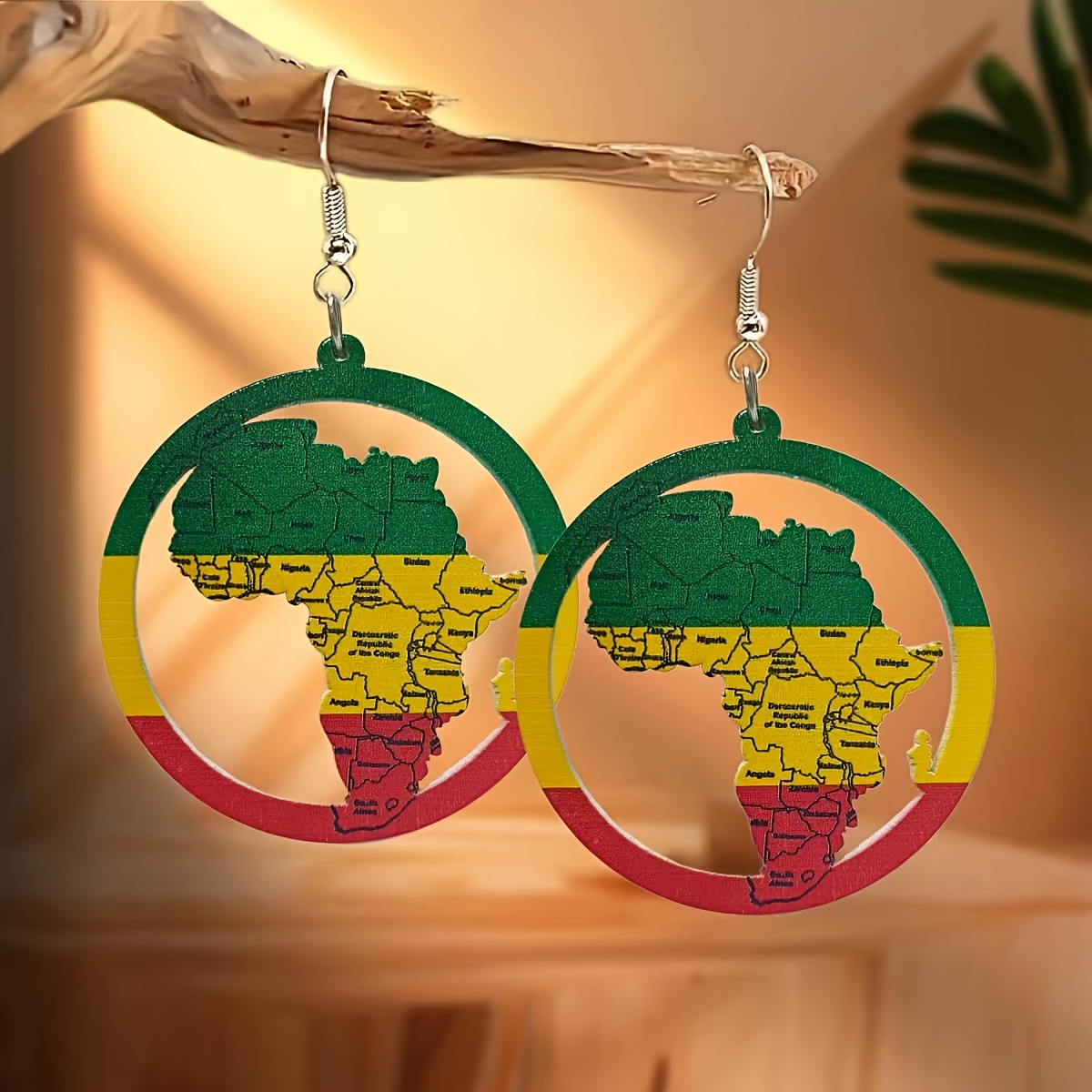 

A Pair Of Vintage-style Large Round Earrings Featuring A Hollow With A African Map, Women. And Come In A Combination Of Green, Yellow, And Red, Making And Stylish.