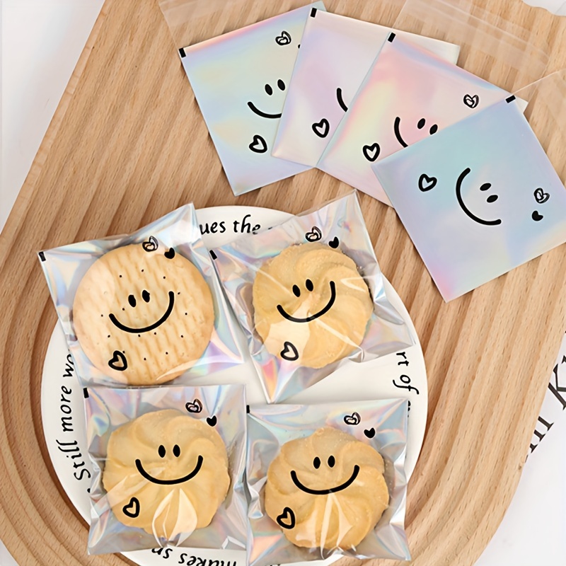 

100pcs Smiling Face Snowflake Crisp Puff Cookie Bags, Self-adhesive Cute Laser Transparent Biscuit Packaging, Birthday Wedding Outdoor Party Supplies