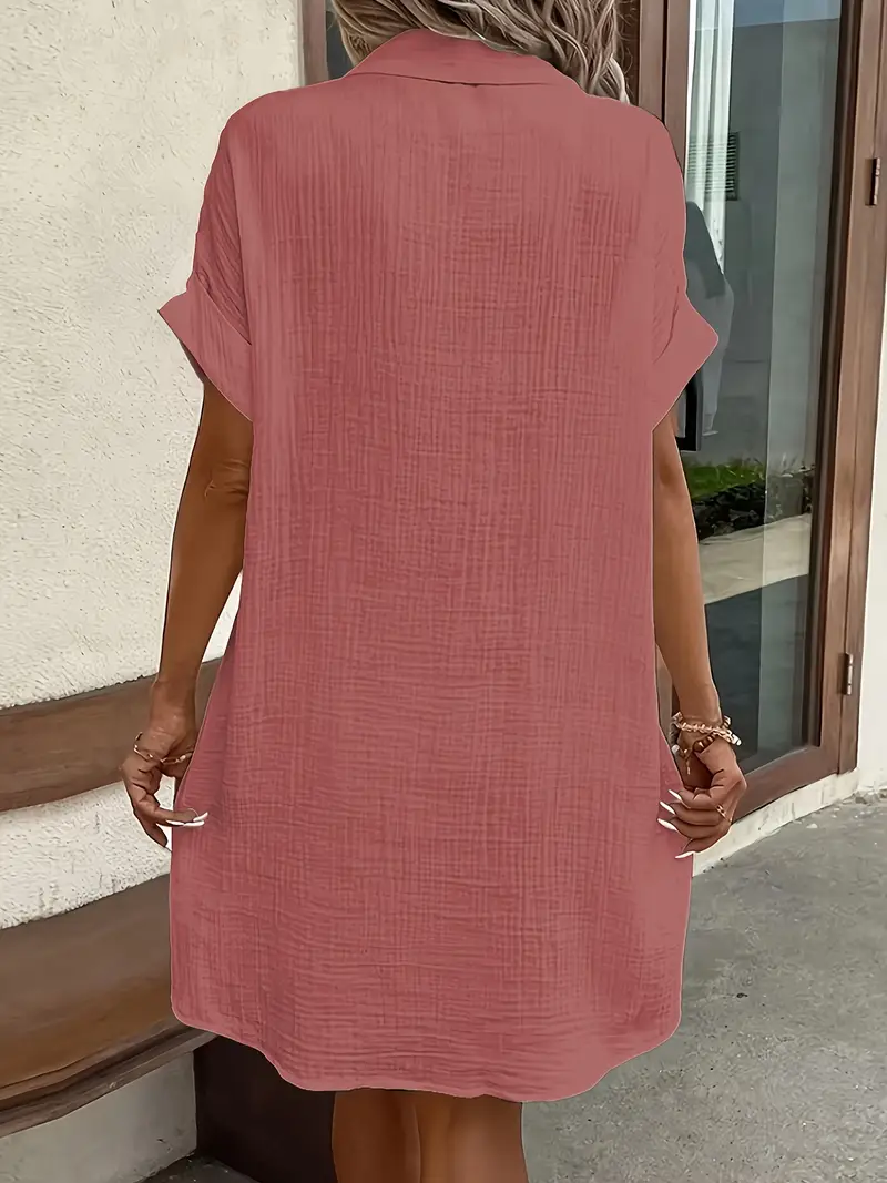 a minimalist white shirt dress made of breathable featuring a sharp collar design and buttons that add a touch of details 1