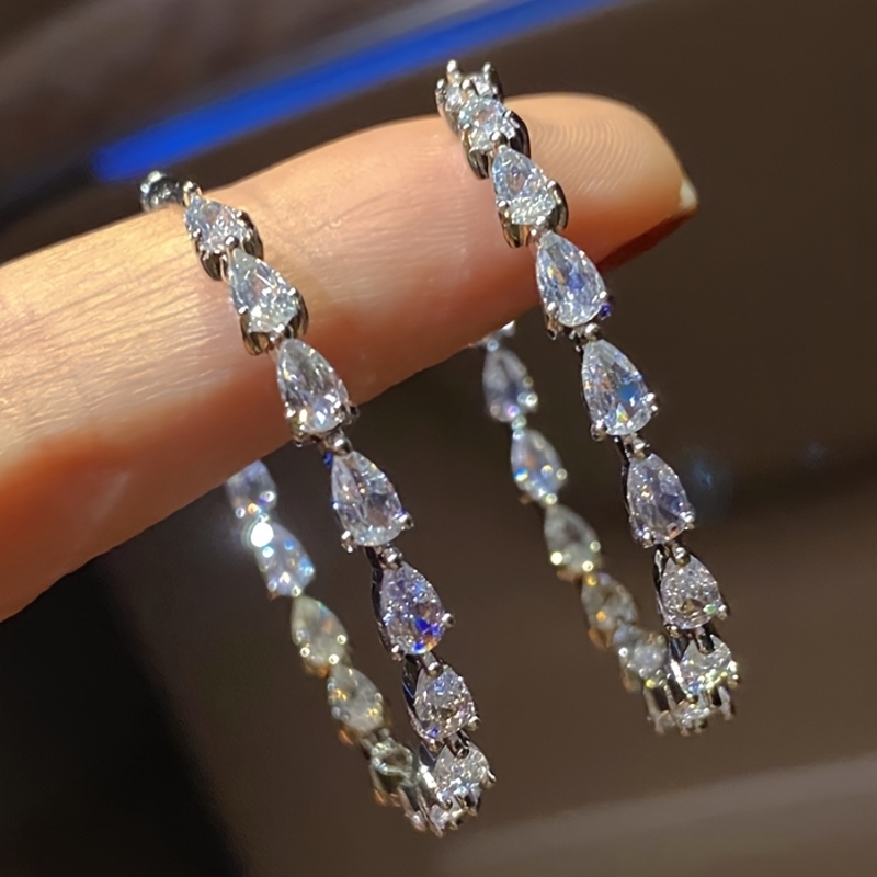 Image of A Pair Of Elegant Circular Earrings For Women, Featuring Teardrop-shaped Cut Zirconia Set In Large Hoops, Perfect For Weddings, Casual , And Fashionable Parties