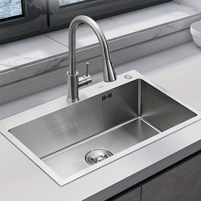 Image of A Single-slot Kitchen Silvery, Made Of Thick Stainless Steel, Measuring 80x50cm, With A Sink That Can Rotate And Extend, Equipped With A Drain Basket And Soap Dispenser.