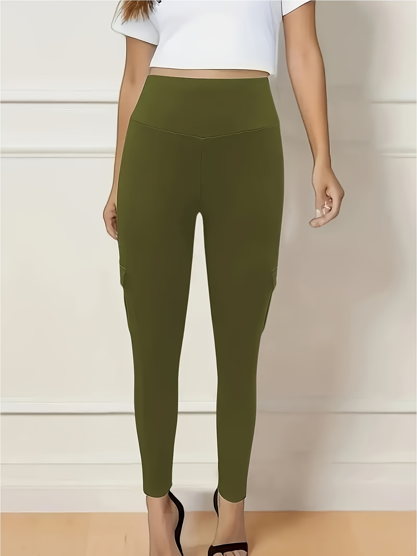 A woman wearing a camouflage yoga leggings sold by 100 Spartans