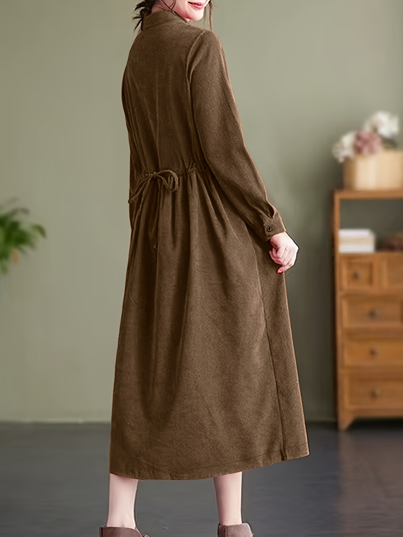 Model wearing a stunning retro Chinese style maxi dress in soft polyester featuring a stand collar button detailing and long sleeves Perfect for autumnwinter