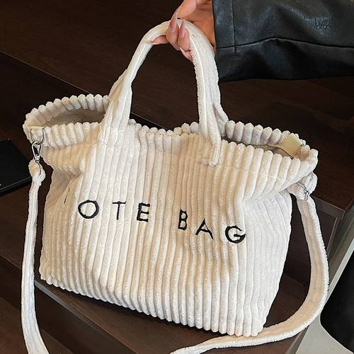 a stylish solid color corduroy tote bag for women featuring a letter design and contrasting elements with an adjustable shoulder strap this versatile and crossbody bag is square shape ideal for professional settings
