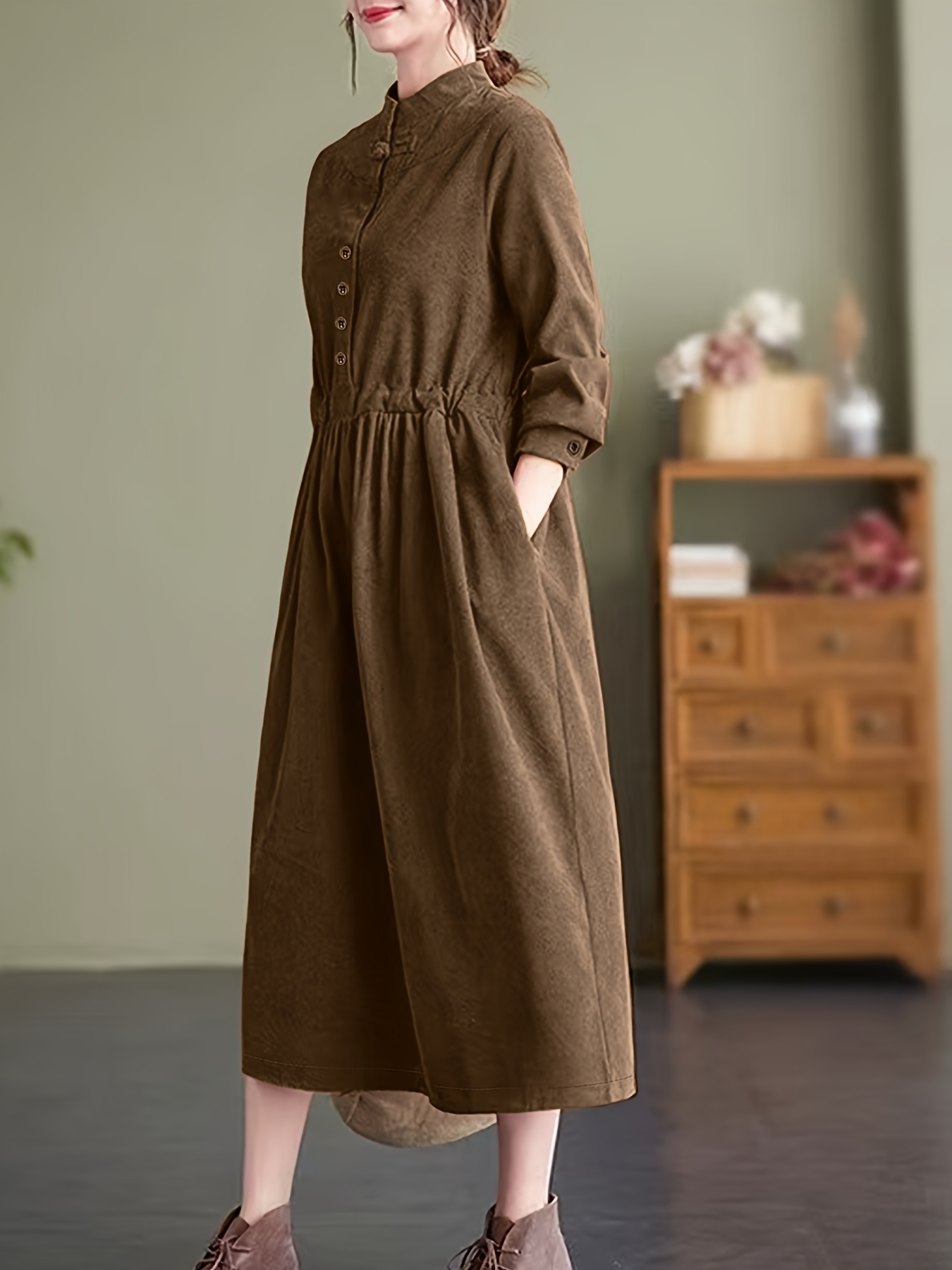 Model wearing a stunning retro Chinese style maxi dress in soft polyester featuring a stand collar button detailing and long sleeves Perfect for autumnwinter