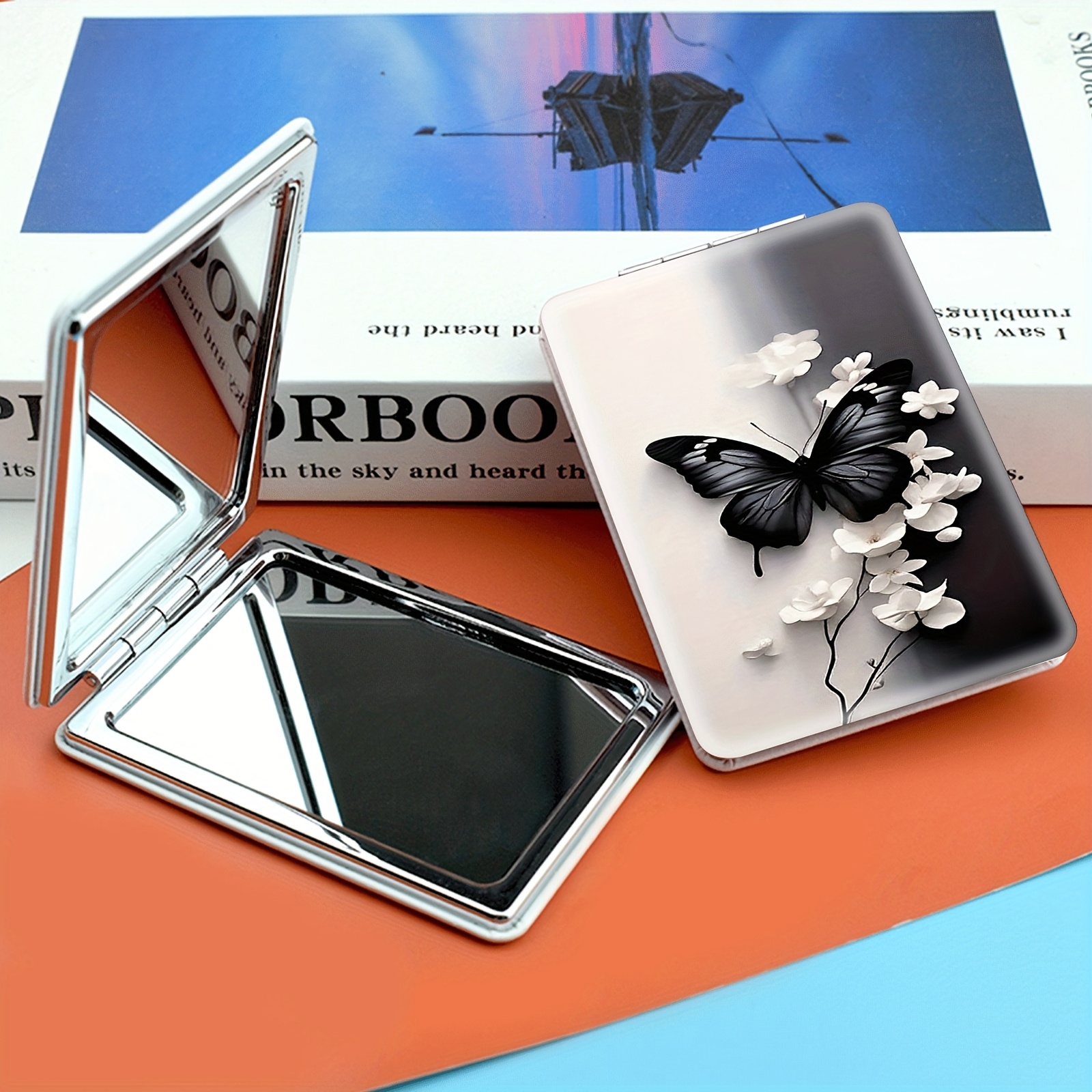 TEMU 1 Portable Folding Makeup Mirror, Featuring A Black Perched Elegantly White Flowers. This Mini Handheld Mirror Is Perfect For Touch-ups On The
