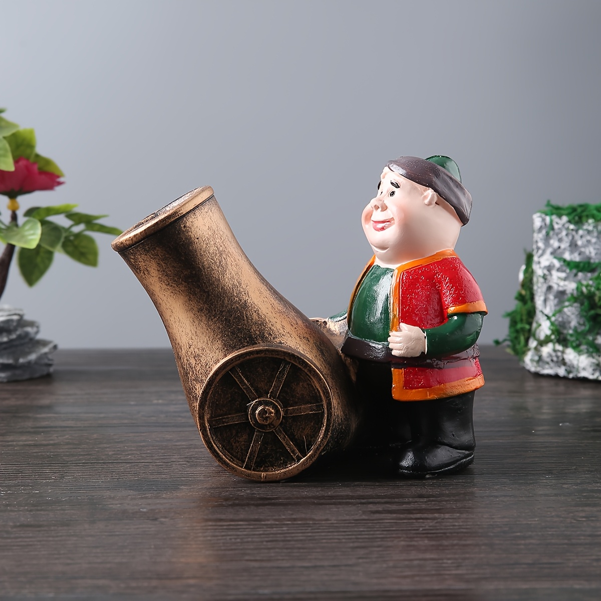 a resin figure of a chubby old man with a cannon suitable for decoration during eid celebrations Product details 5