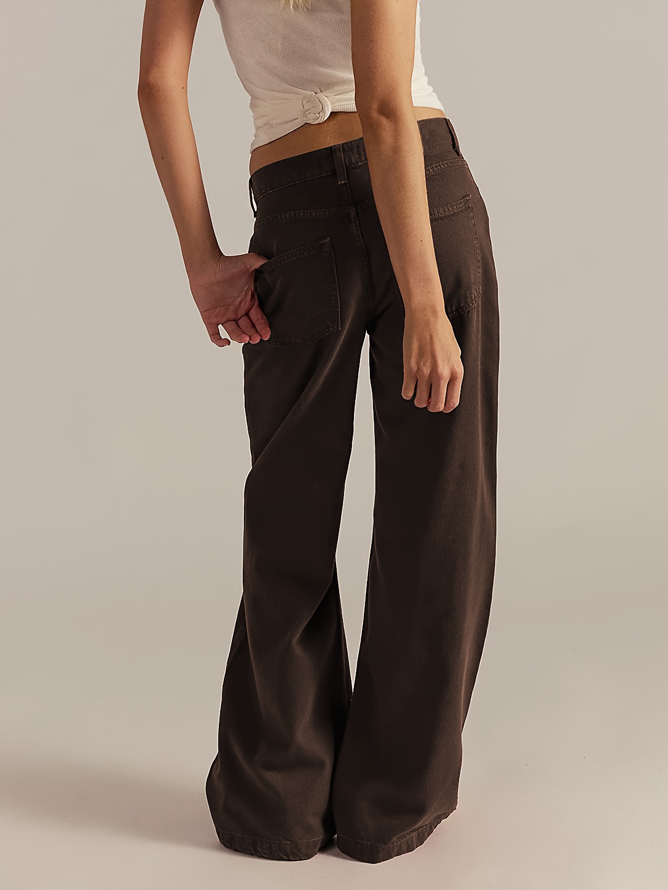 Model wearing the dark brown wide-leg denim pants