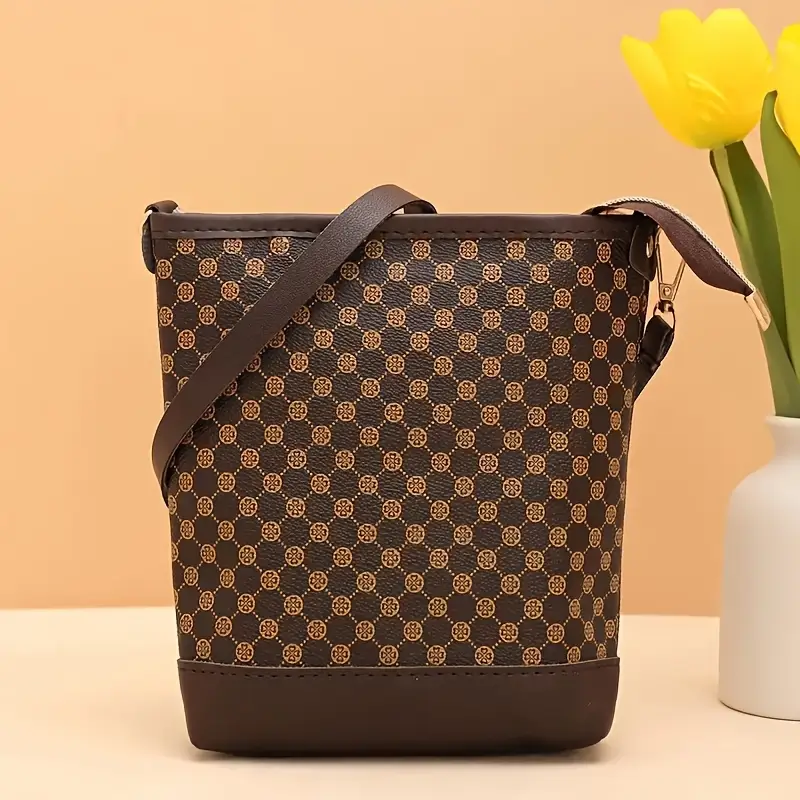 a vintage geometric patterned crossbody bag featuring a lightweight adjustable shoulder strap a zip closure polyester lining capacity and pockets for a phone and a versatile bag suitable for occasions details 1