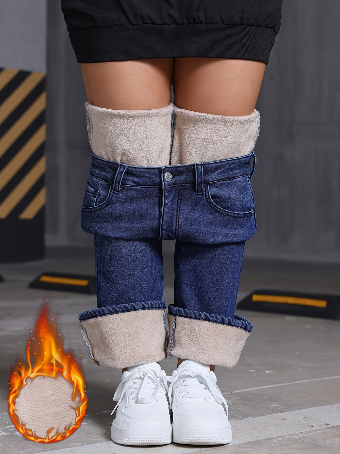 Close-up of the zipper button closure and denim texture