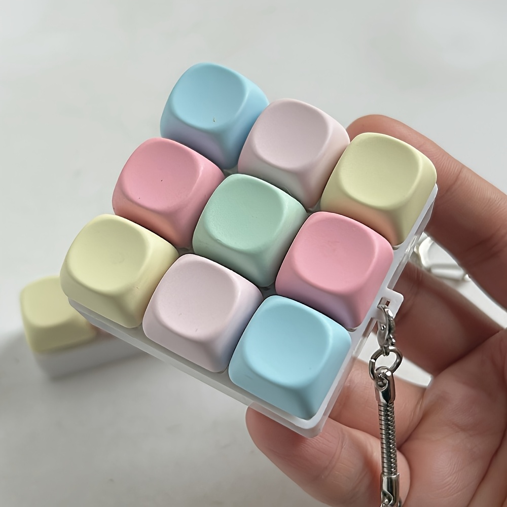 1pc mini mechanical keyboard keychain a portable typing accessory   travel and office use the keychain with colorful buttons and chain is specifically designed for typing enthusiasts