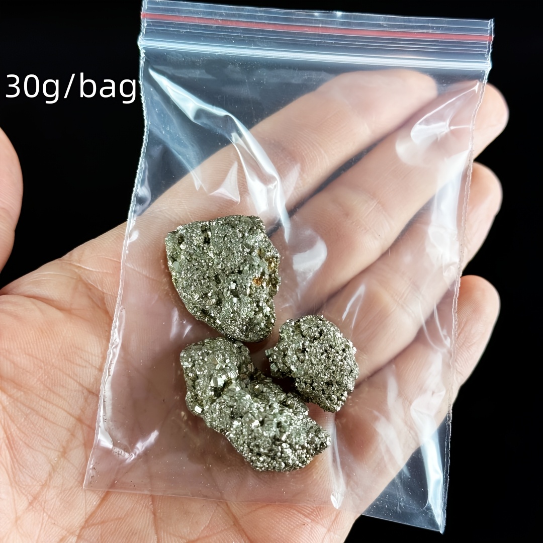 Image of A Bag Of Stones In Irregular Shapes, Semi- Are Perfect For Reiki, And Make Great Collectible Gifts Resembling Fool's Golden