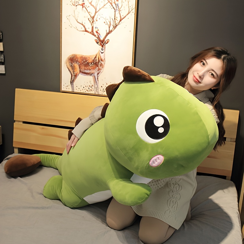 adorable green dinosaur plush doll with oversized cartoon eyes and   featuring a brown spiky   that replicates dinosaur characteristics   cute and   it   a perfect birthday or christmas gift for  