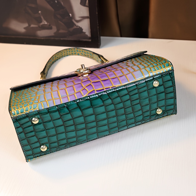 Crocodile Handbag held by hand close-up