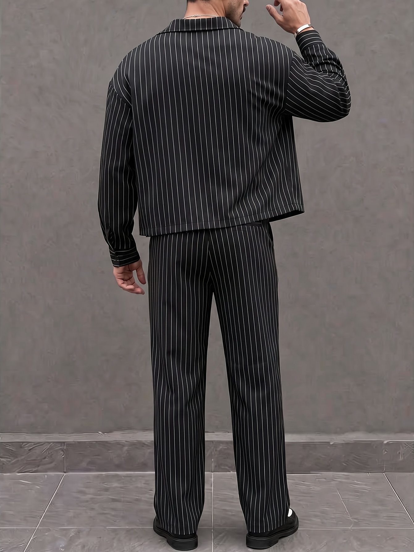 mens black 2pcs suit with thin vertical stripes featuring a short loose fit jacket and loose fit trousers a relaxed gourd   for men offering a sharp and   look suitable for   commuting and parties