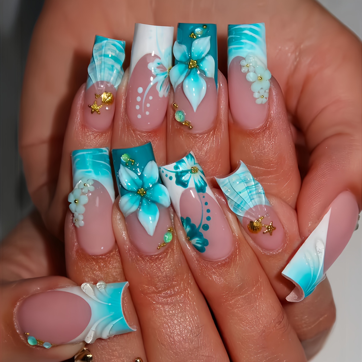A Set of 24 Square Press-on False Nails Featuring Elegant Teal Blue Floral Patterns, Stylish Artistic Stripes, Cute Starfish and Seashell Designs, and Luxurious Golden Beads. Suitable for All Women and. The Box Includes a Nail Buffer and Jelly