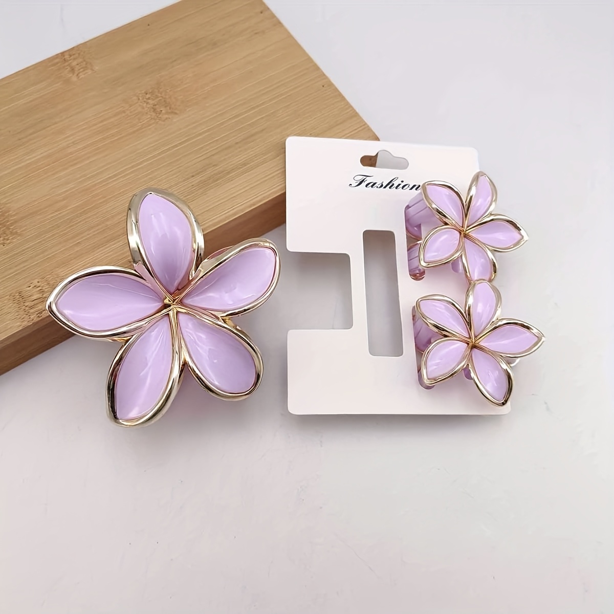 3 carded gold simulated frangipani plastic hair claw - Temu Oman