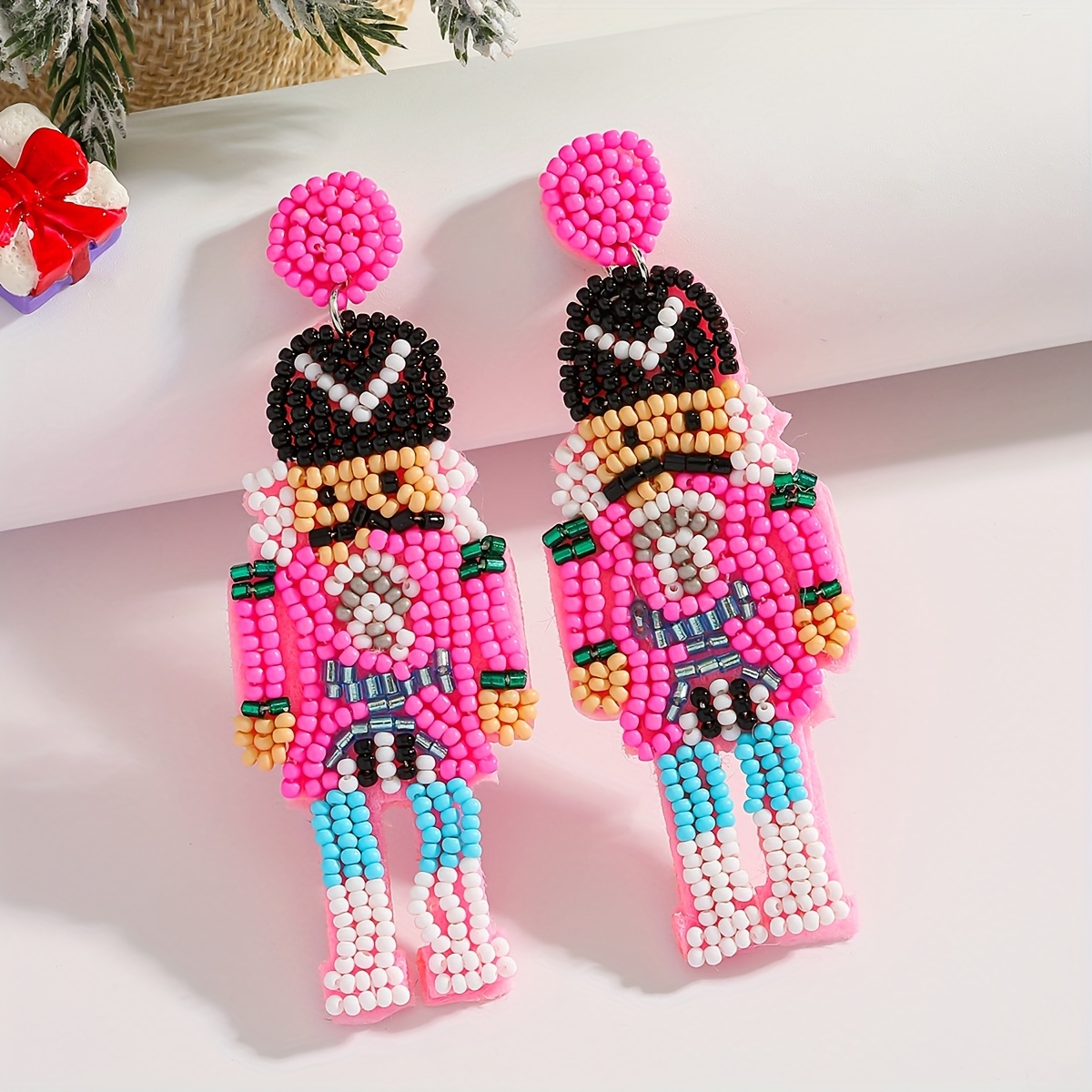 TEMU A Pair Of Handcrafted Christmas Earrings Featuring A Pink Nutcracker Lady Made Of Rice Beads, In Multiple Colors, Showcasing Colorful Mustached